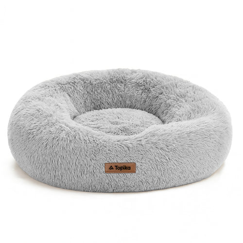 Gray fluffy donut pet bed with Topika label on a white background