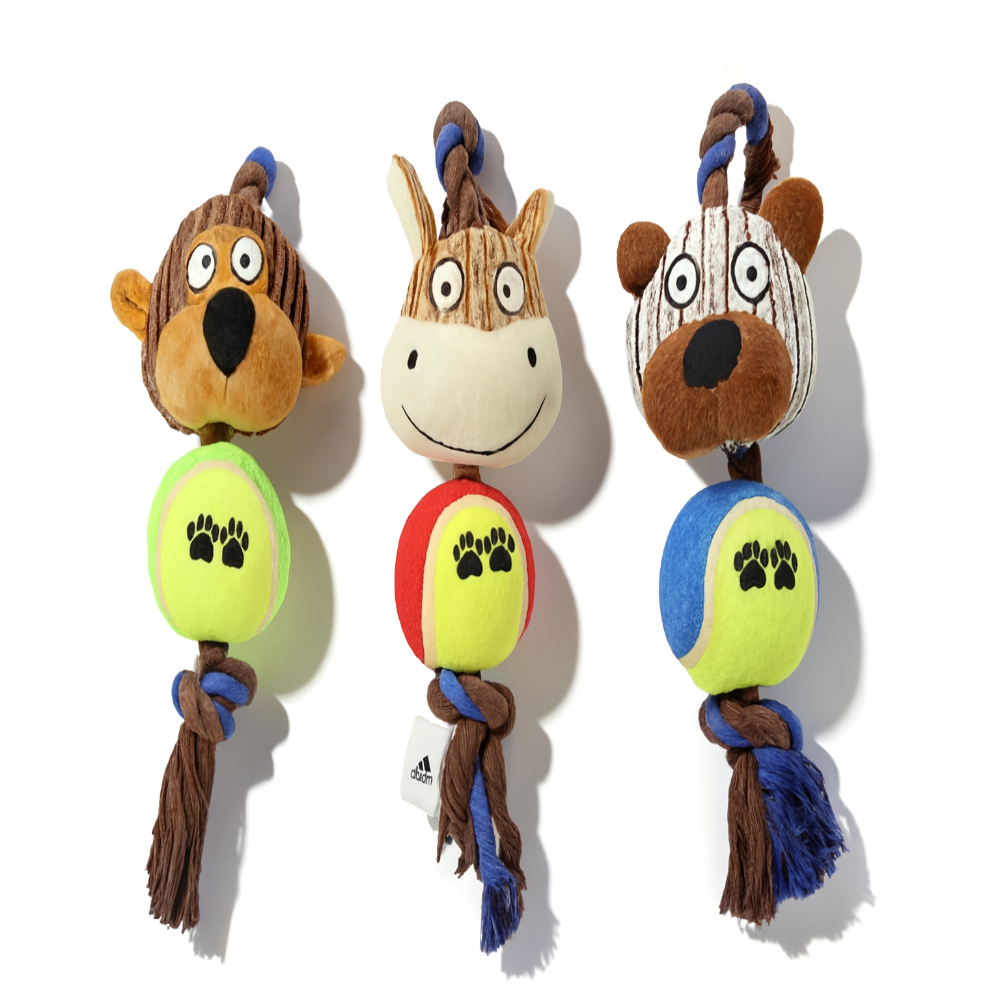Three animal-themed dog toys with colorful balls and tassels on a white background